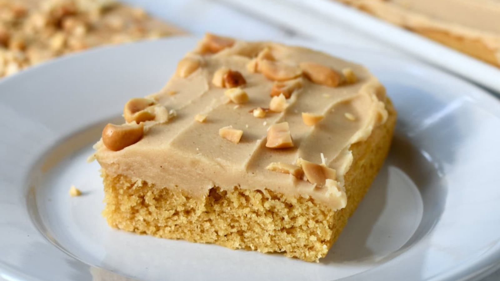A slice of sheet cake with peanut butter on top.