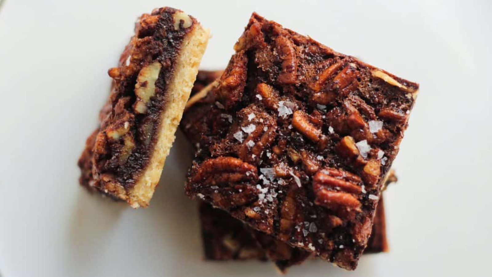 Pecan bars on a white surface.