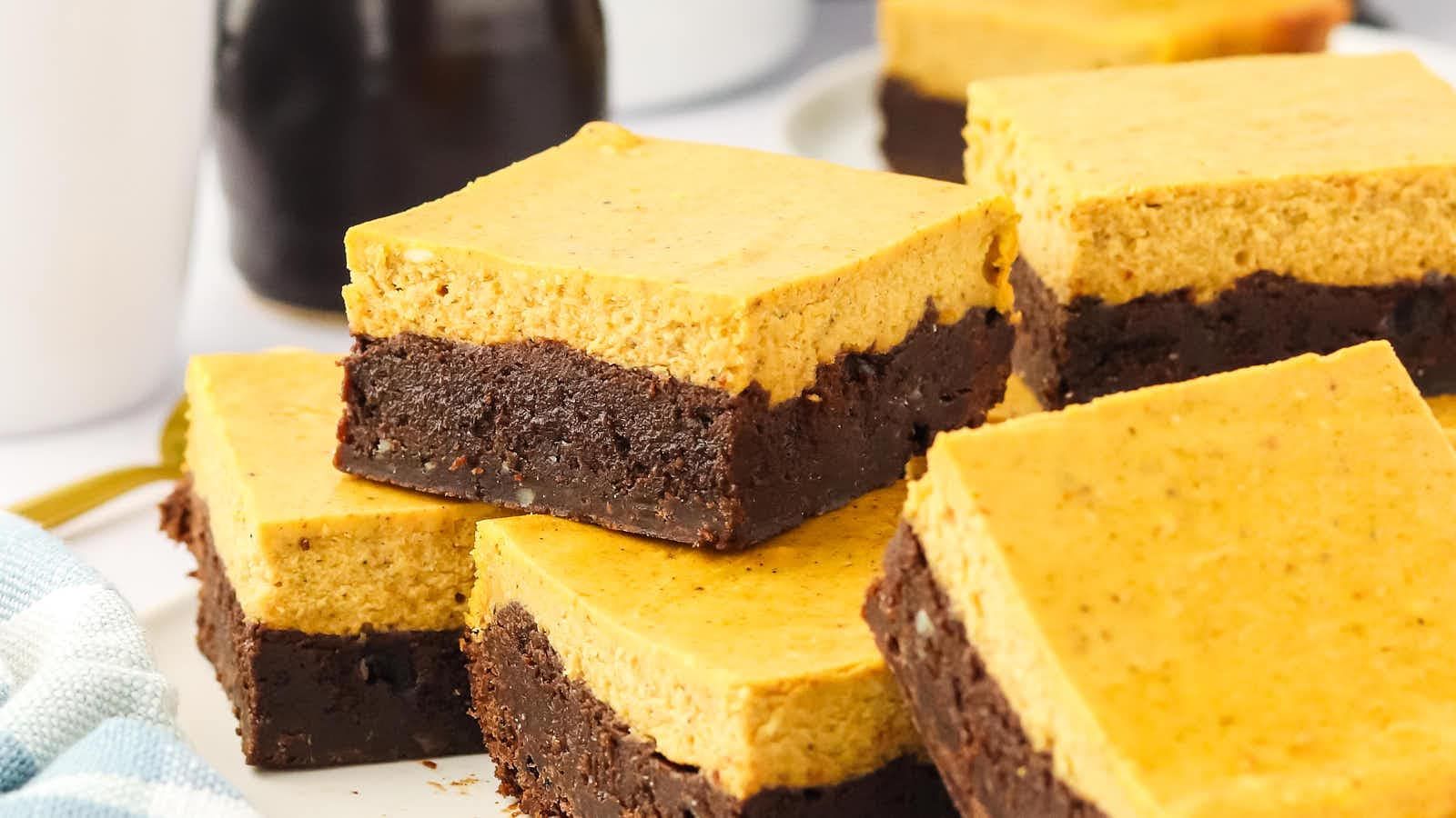 Stacks of pumpkin cheesecake brownies.