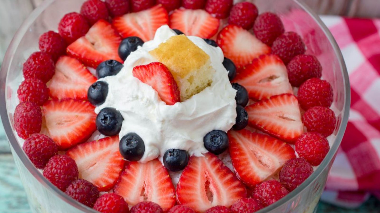 Cheesecake trifle with berries on top.