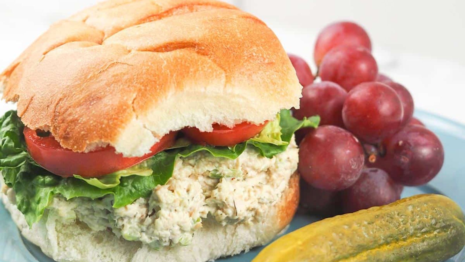 Turkey burger with grapes on the side.