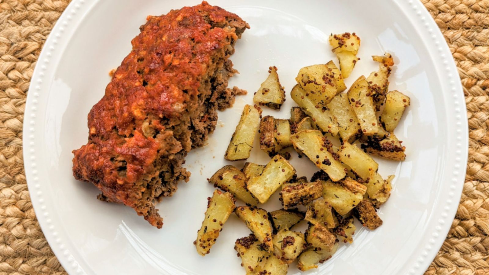 Meatloaf with potatoes on a plate.