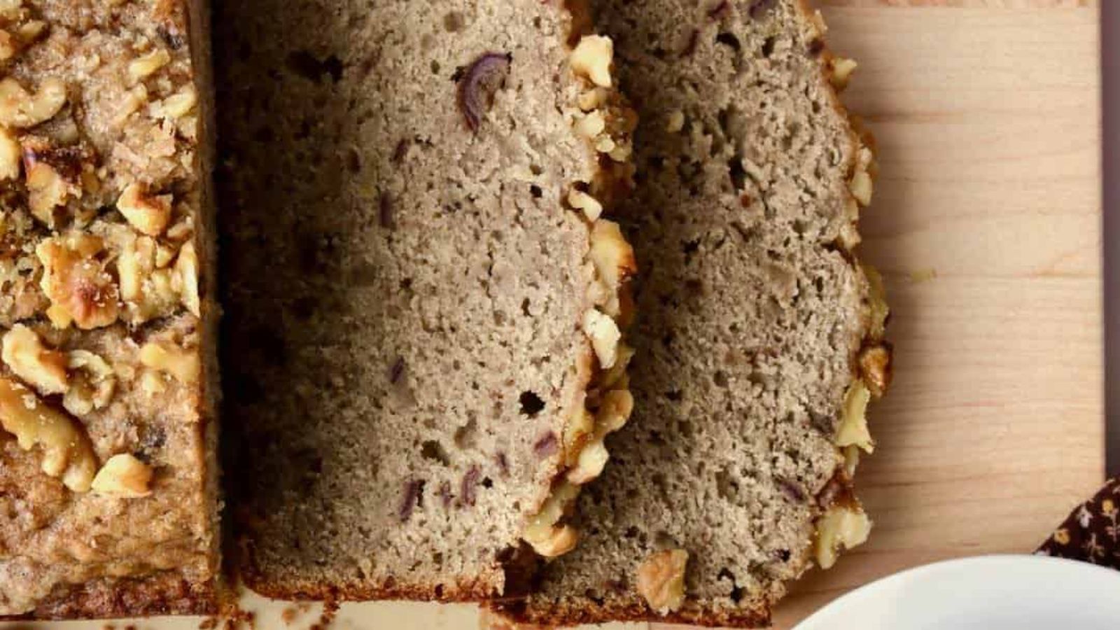 Slices of banana bread on a wooden board.