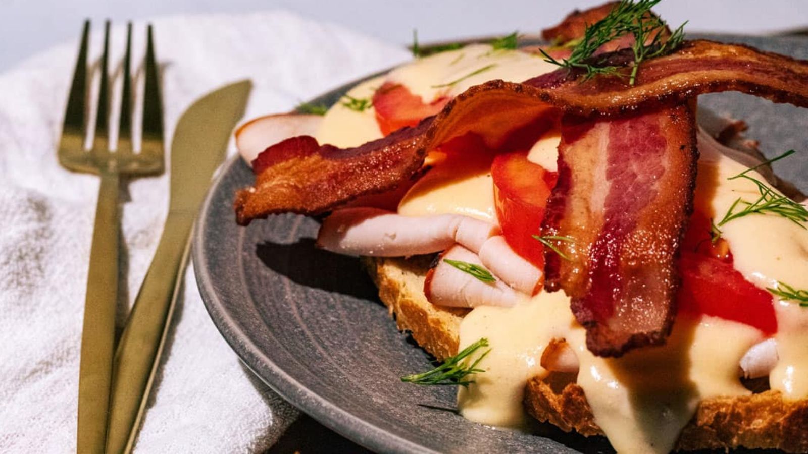 Sandwich with bacon on top.