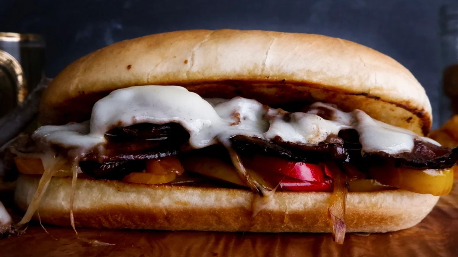 Venison philly cheesesteak on a wooden board.