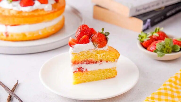 A slice of strawberry cake on a plate.