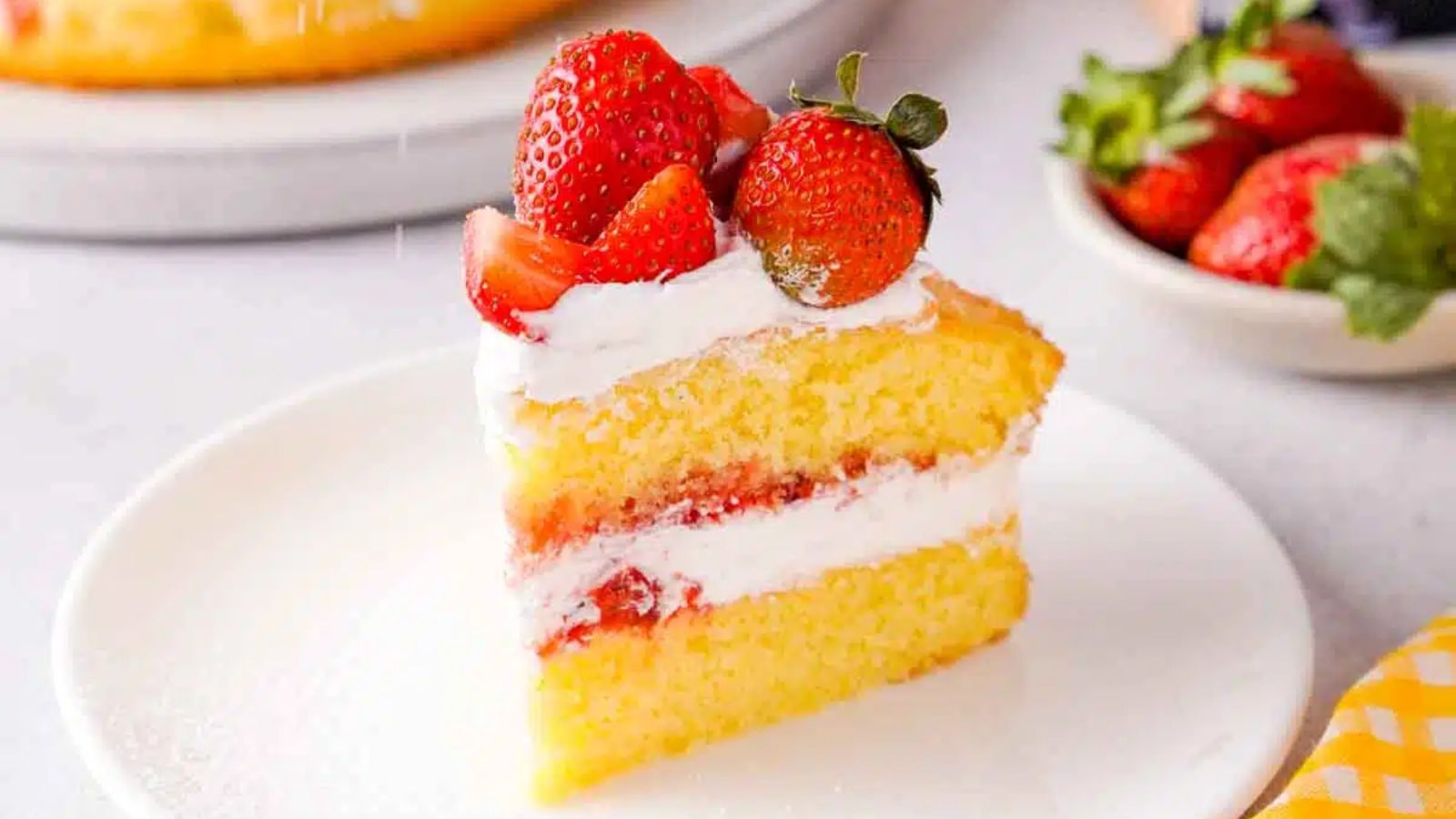 A slice of strawberry cake on a plate.