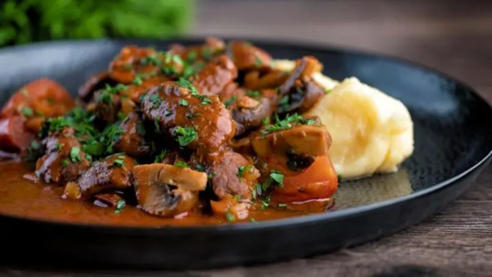 Stew with mushroom on a plate.