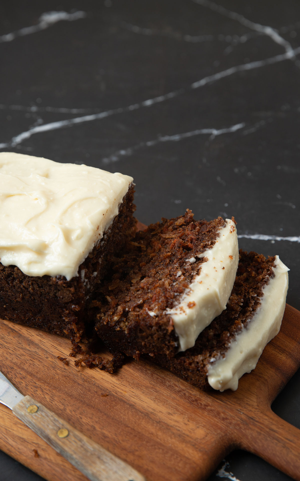 Slices of carrot cake bread on a cutting board.