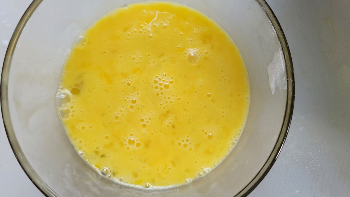 Whisked eggs in a bowl.