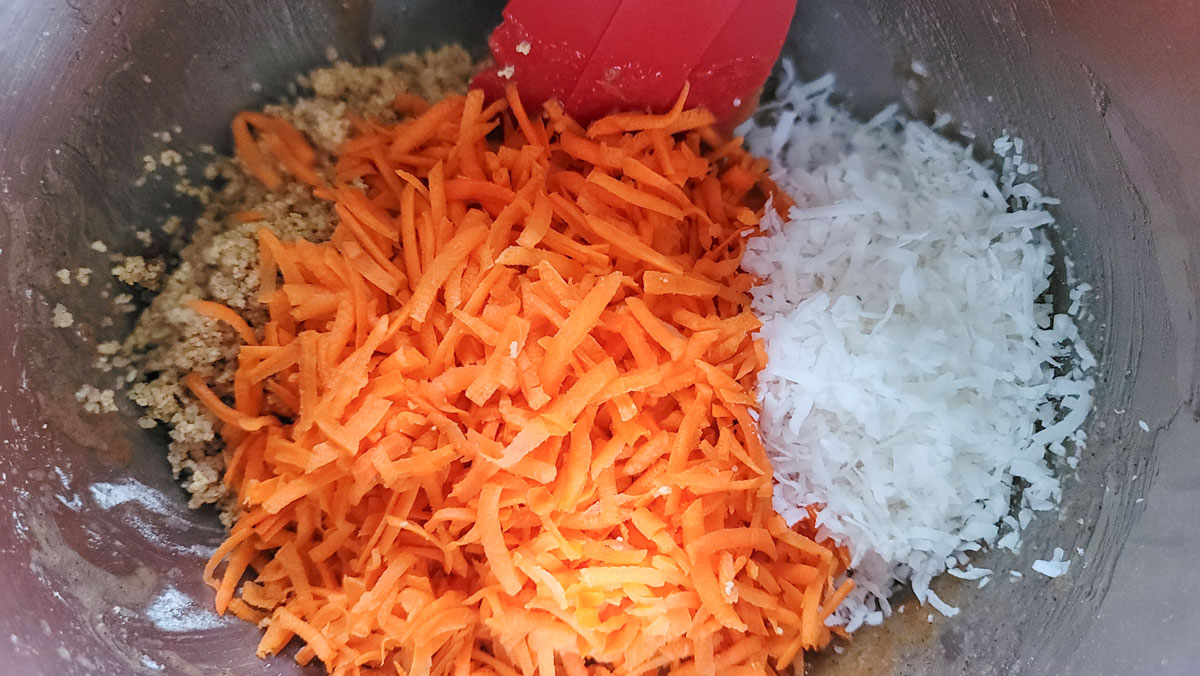 Nuts, coconut and carrots added to the bowl.