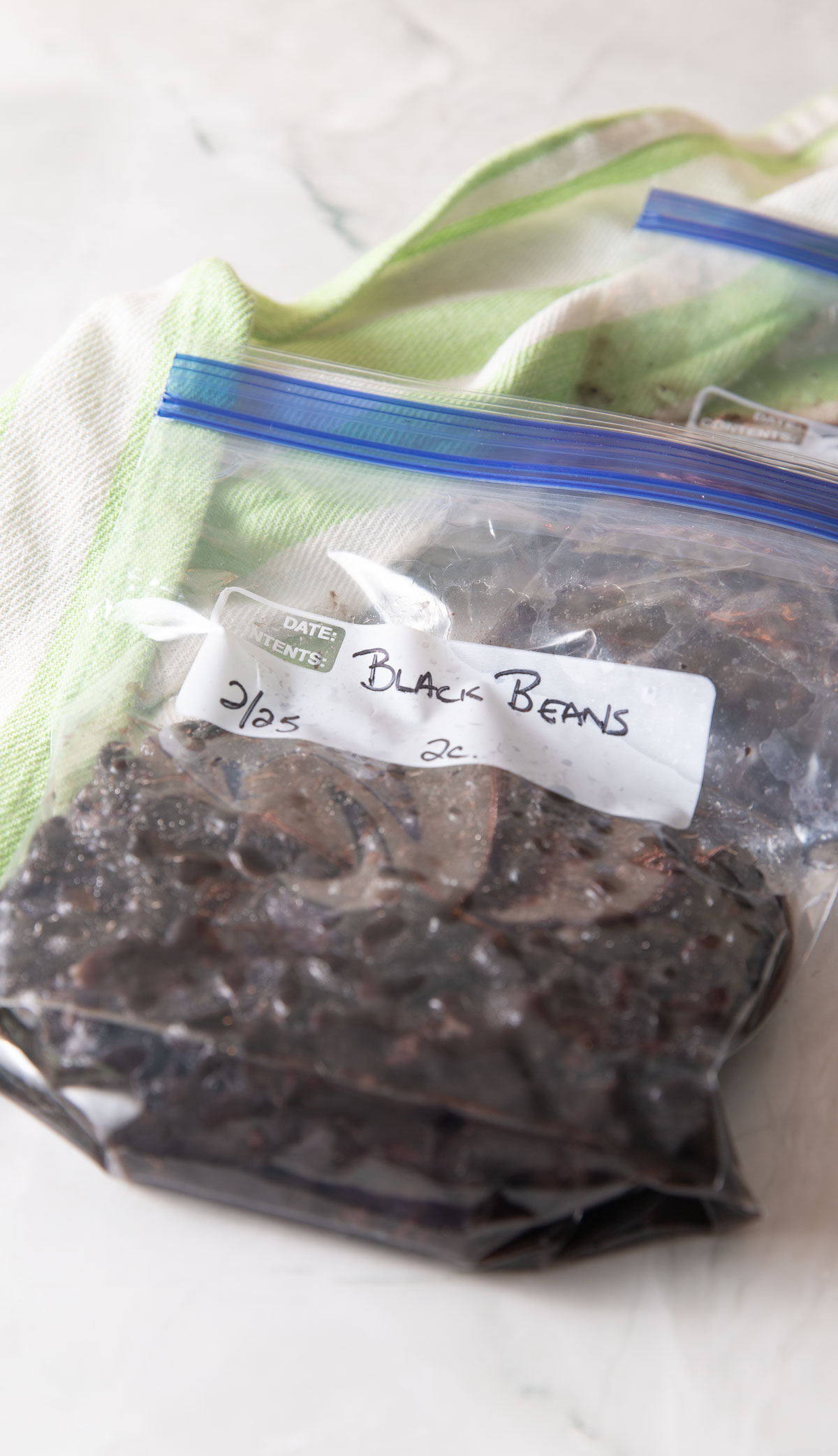 Two freezer bags filled with cooked black beans.