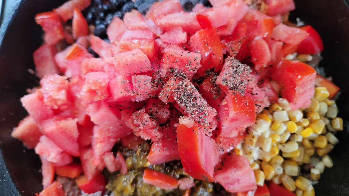 Tomatoes and spices added.