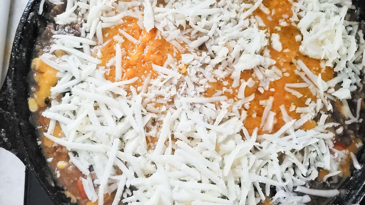 Cheese added to the skillet.