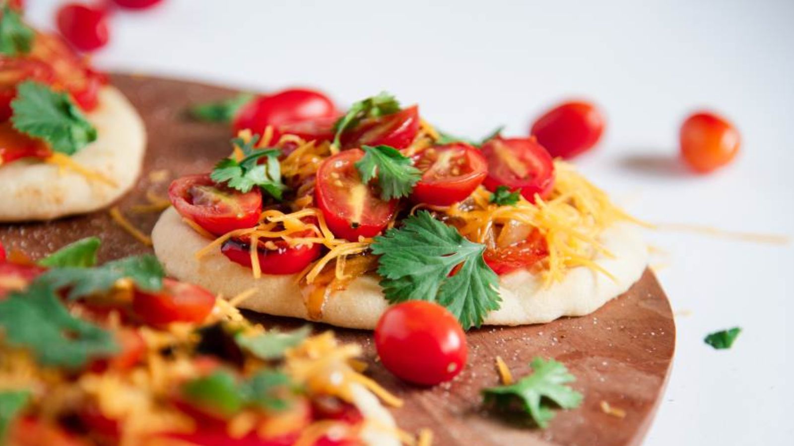 Sandwich with cherry tomatoes on a wooden board.