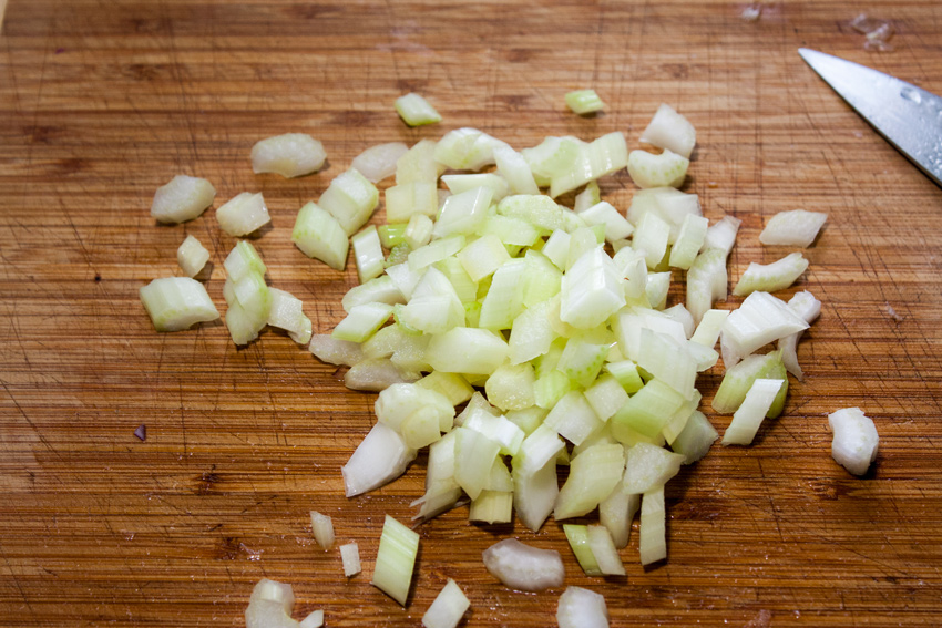 Chopped celery on a cutting board.