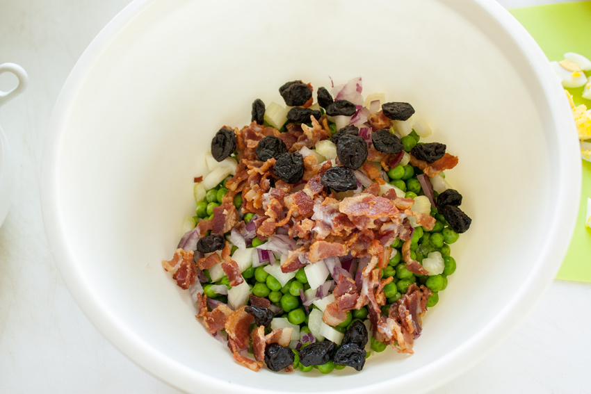 Ingredients for salad in a bowl with the peas.