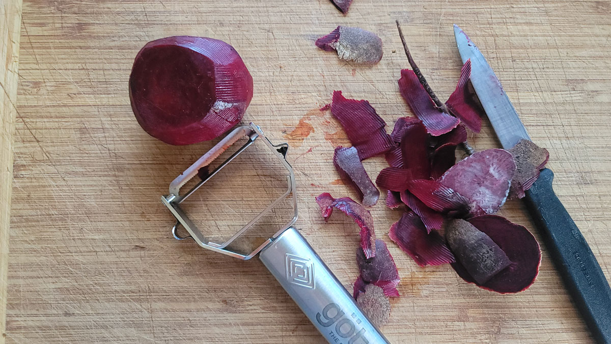 Beets on a board with peelings.