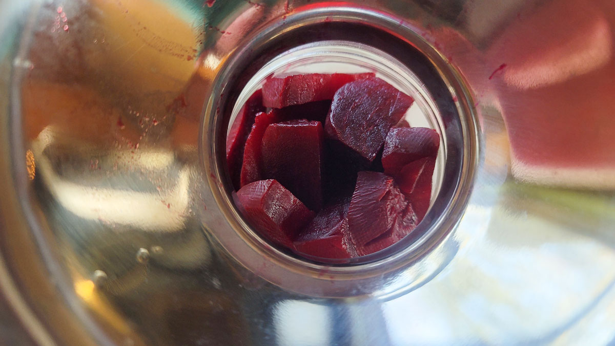 Beets loaded into a jar.