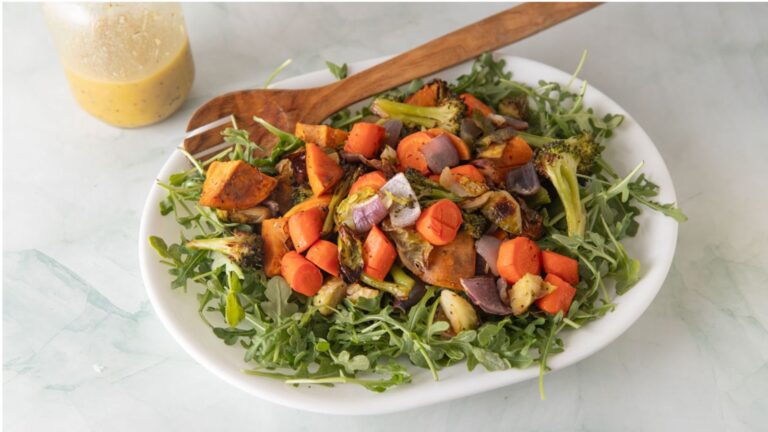Roasted vegetable salad on a bed of arugula.