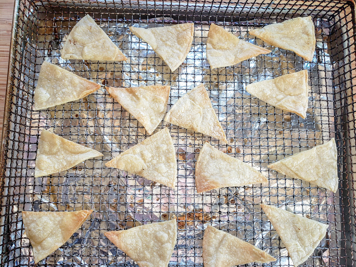 Golden brown chips on the air fryer basket.
