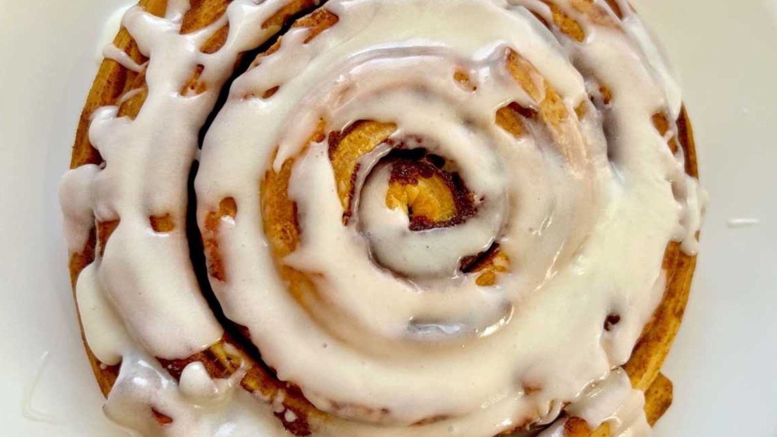 Cinnamon roll with cream.