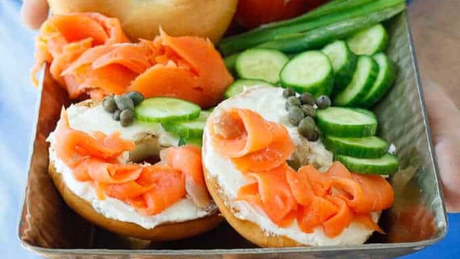 Bagels and lox with cucumbers.