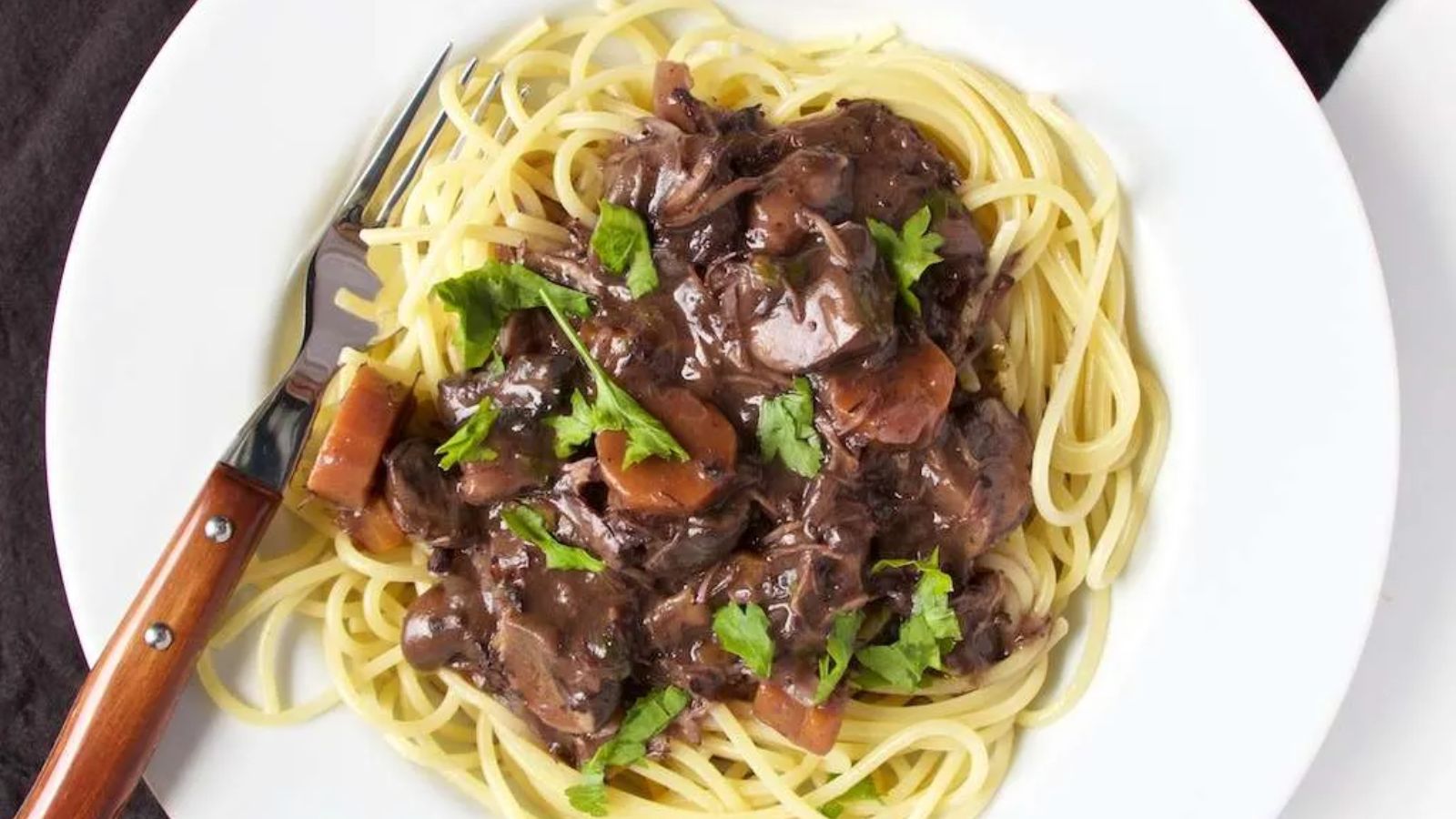 Pasta with beef bourguignon on a plate.