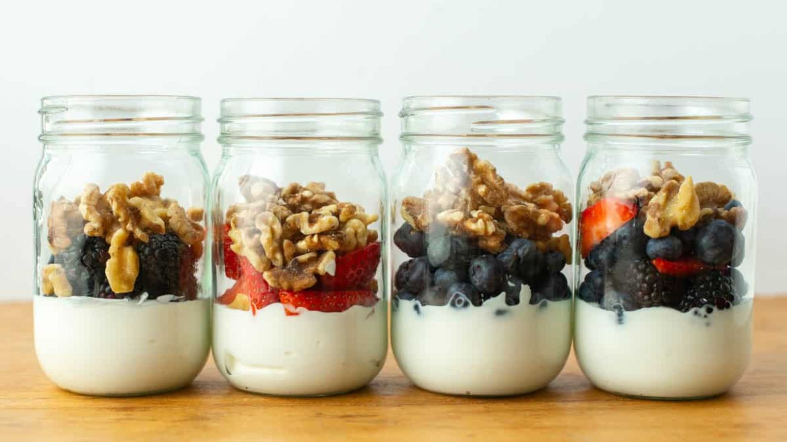 Berry yogurt parfait in jars.