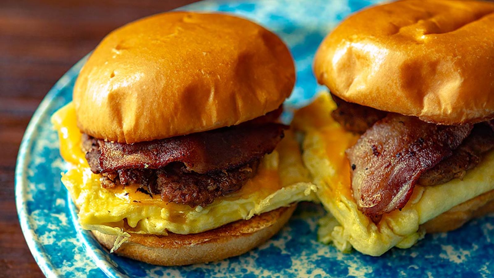 Two brioche sandwich on a plate.