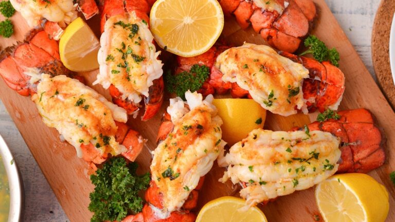 Lobster tails on a wooden board.