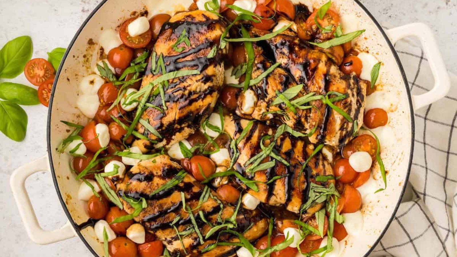Caprese chicken in a pan.