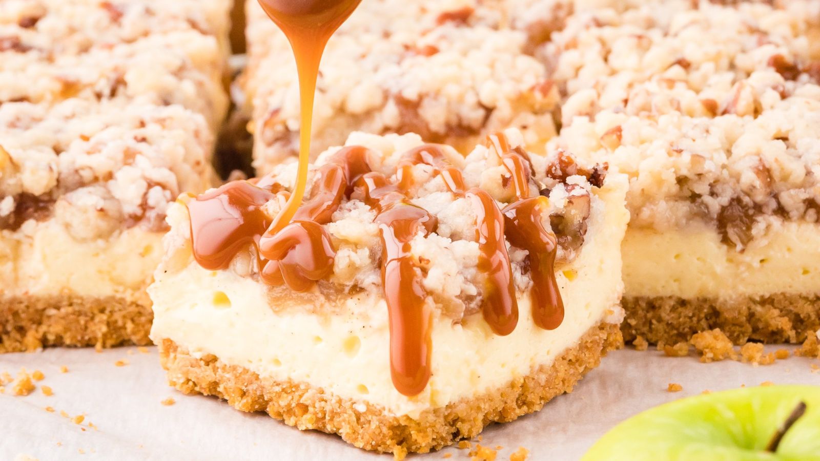 Apple cheesecake bars slices with caramel sauce.