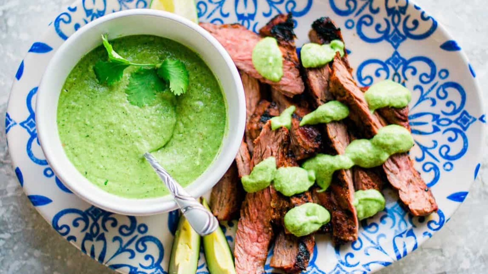 Sliced carne asada on a plate.