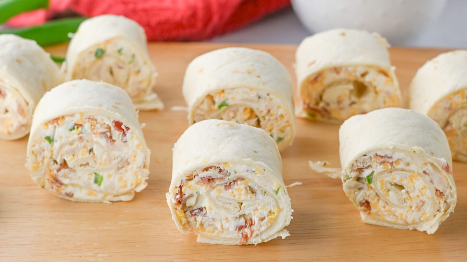 Chicken pinwheels on a wooden board.