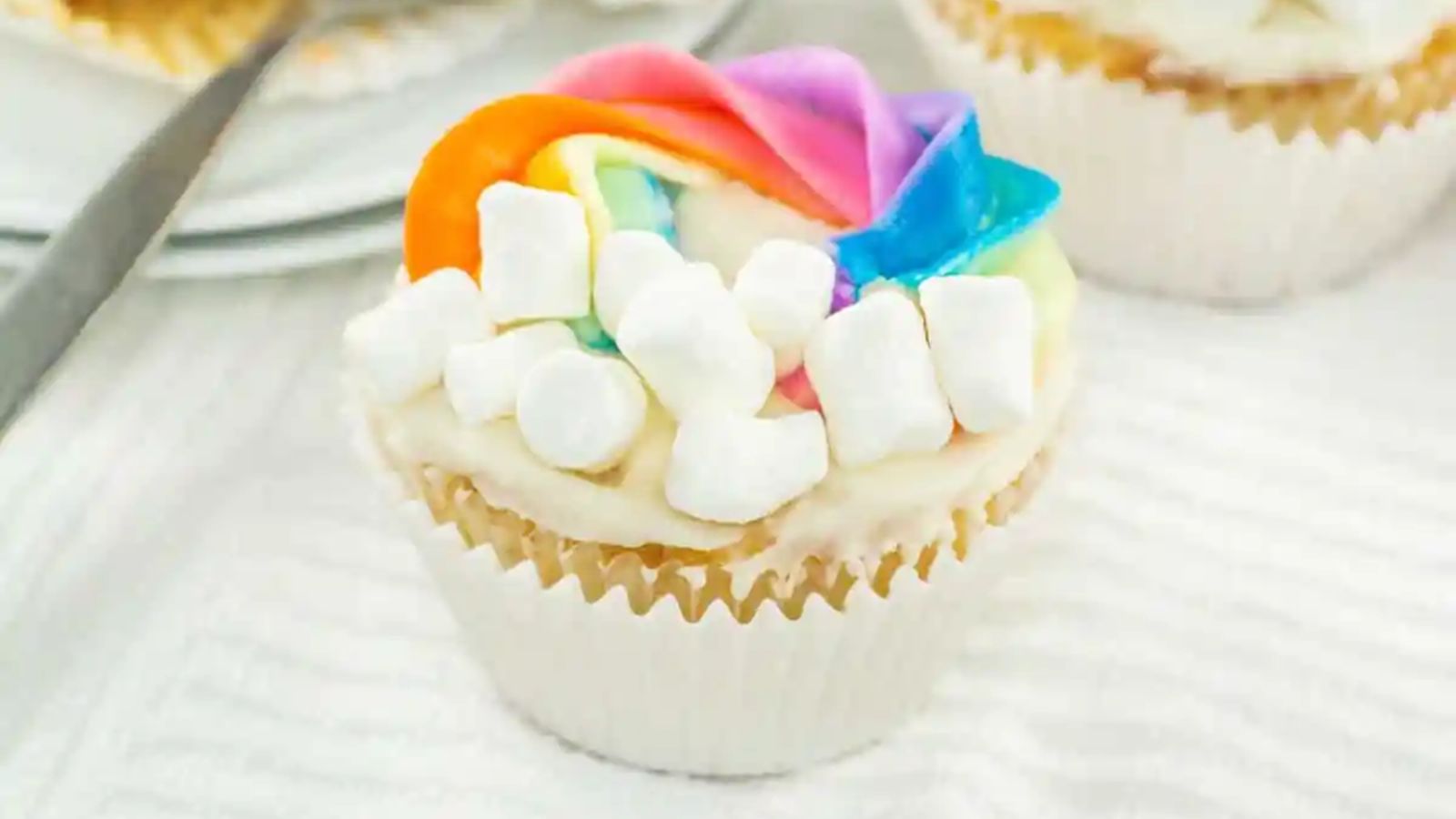 Cupcake with rainbow frosting.