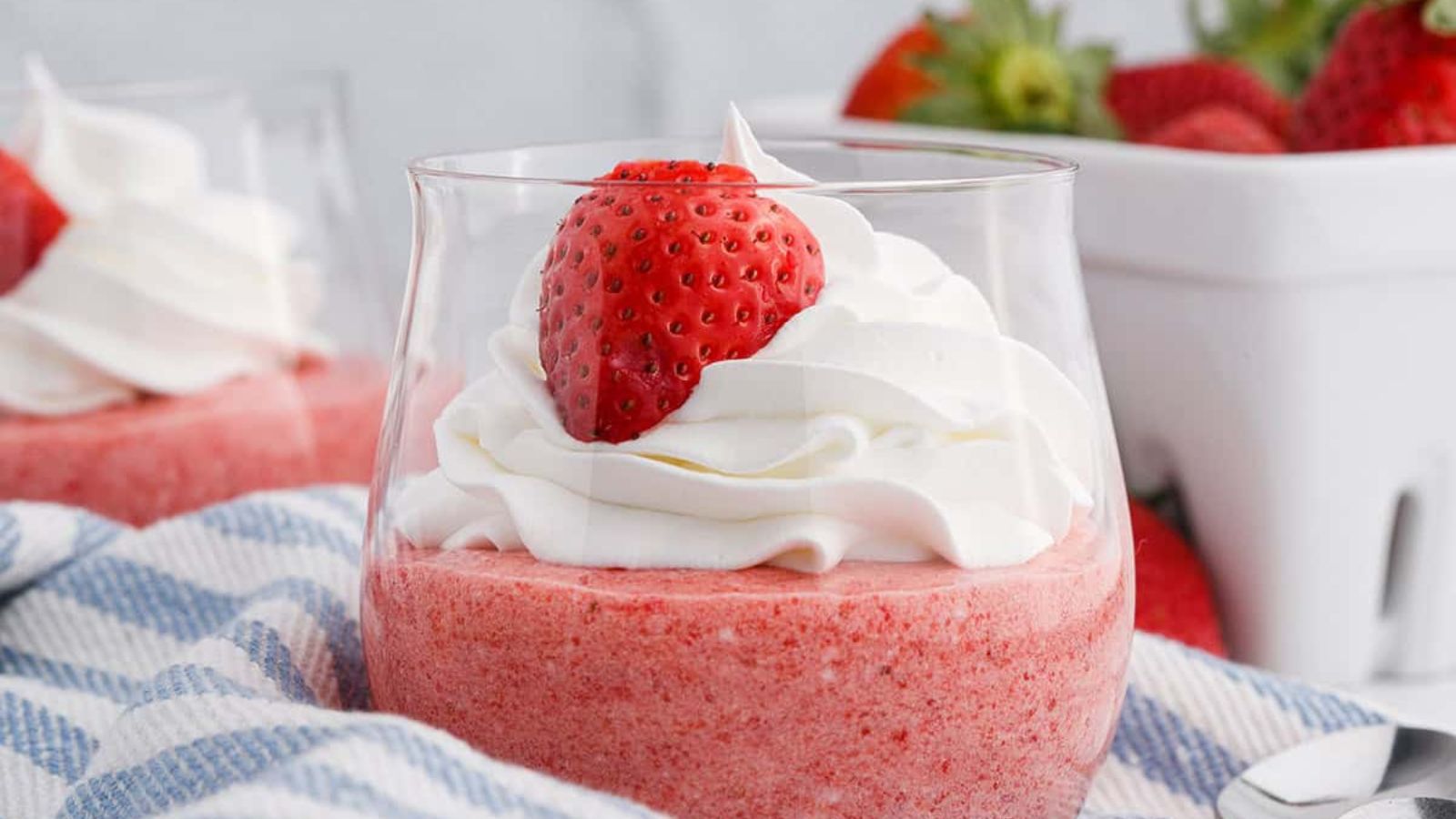 A glass of strawberry mousse.