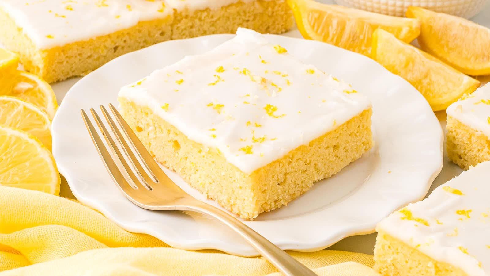 A slice of lemon sheet cake on a plate.