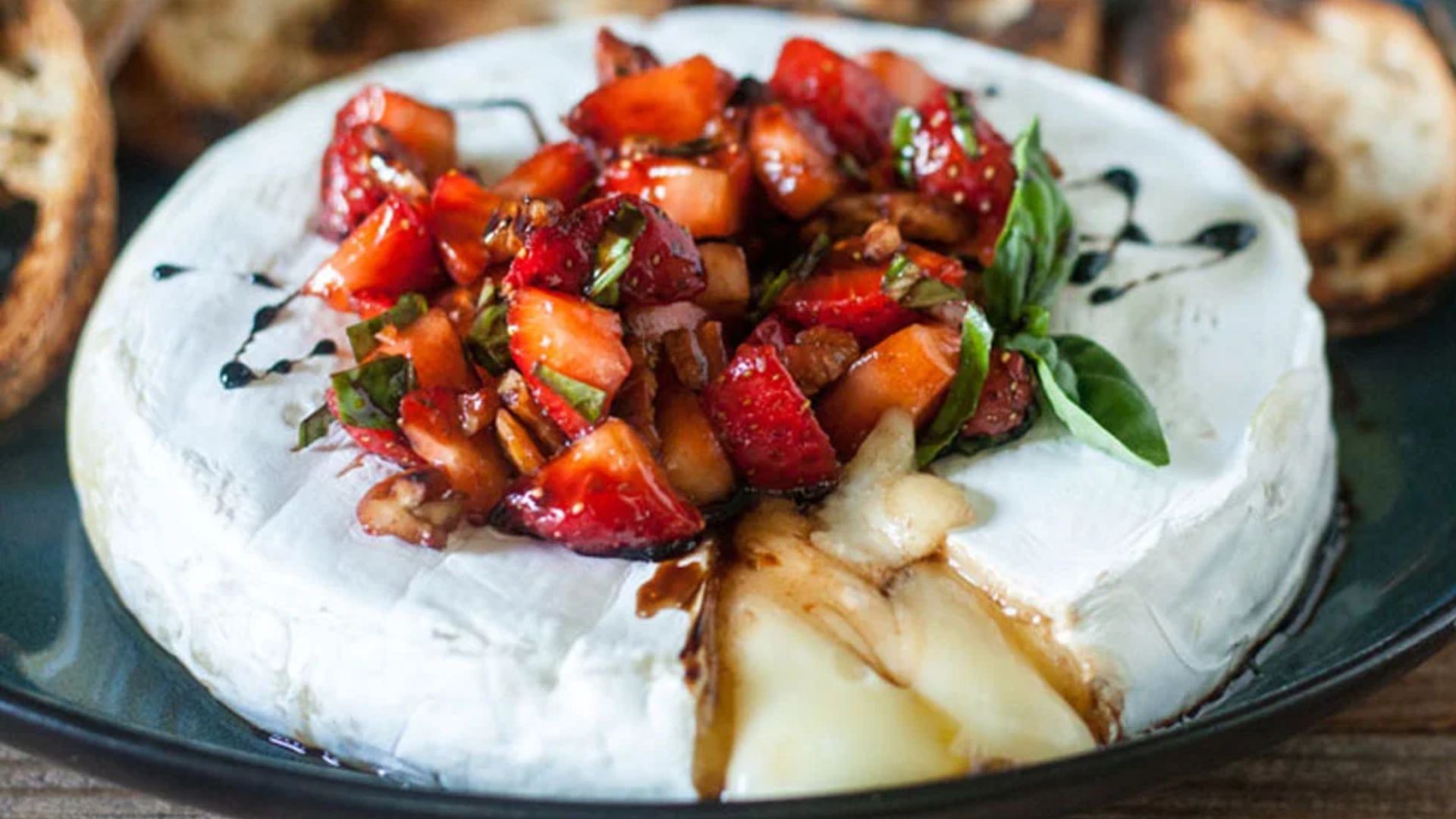 Brie cheese with strawberries on top.