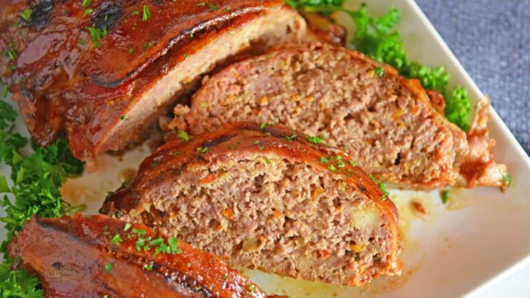 Slices of meatloaf on a wooden board.
