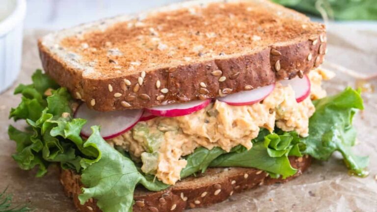 Chickpea sandwich on a wooden board.