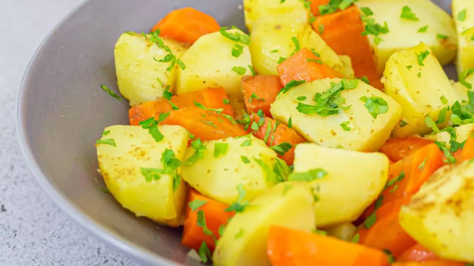 Carrots and potatoes in a bowl.