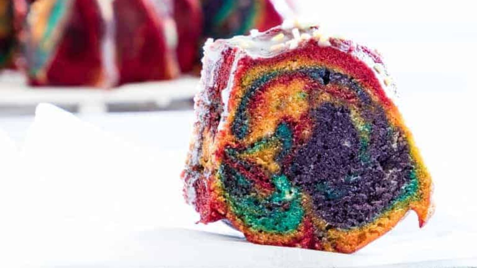 A slice of rainbow bundt cake.