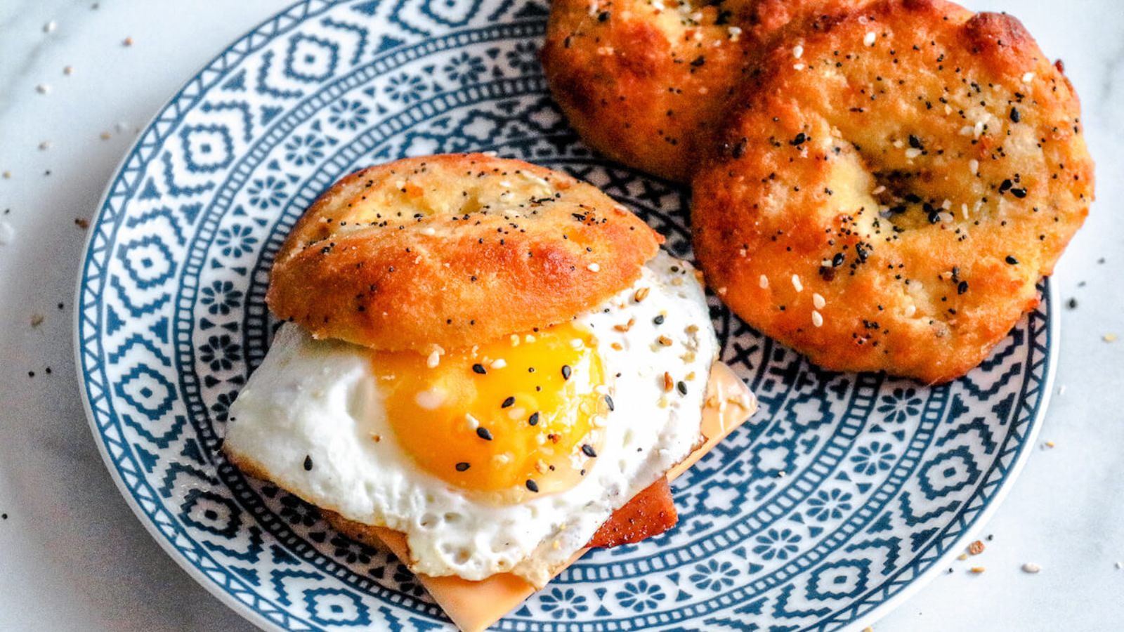 Bagels with eggs on a plate.