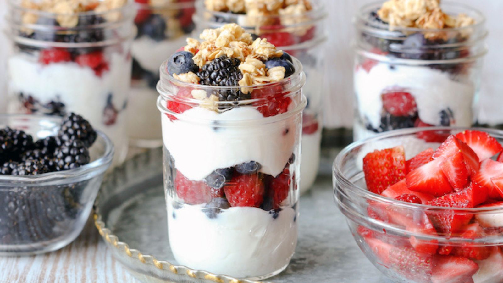 Fruit yogurt parfaits in jars.