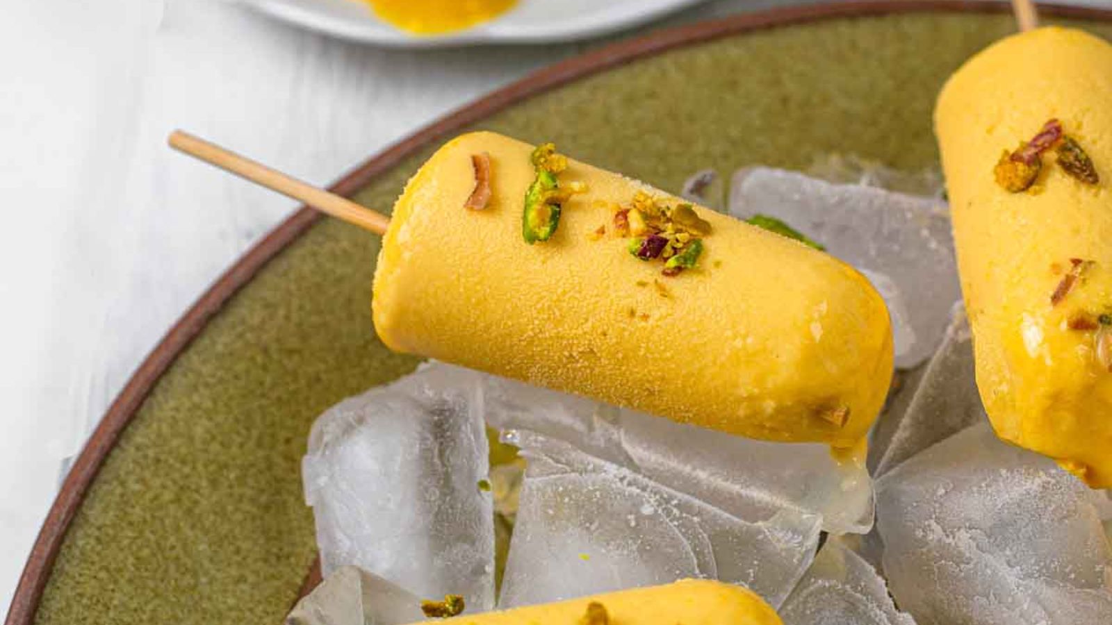 Mango popsicles on ice cubes.