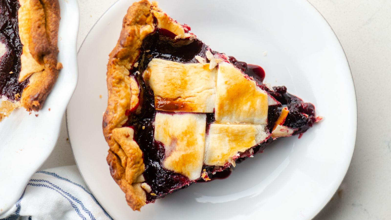 A slice of marionberry pie on a plate.