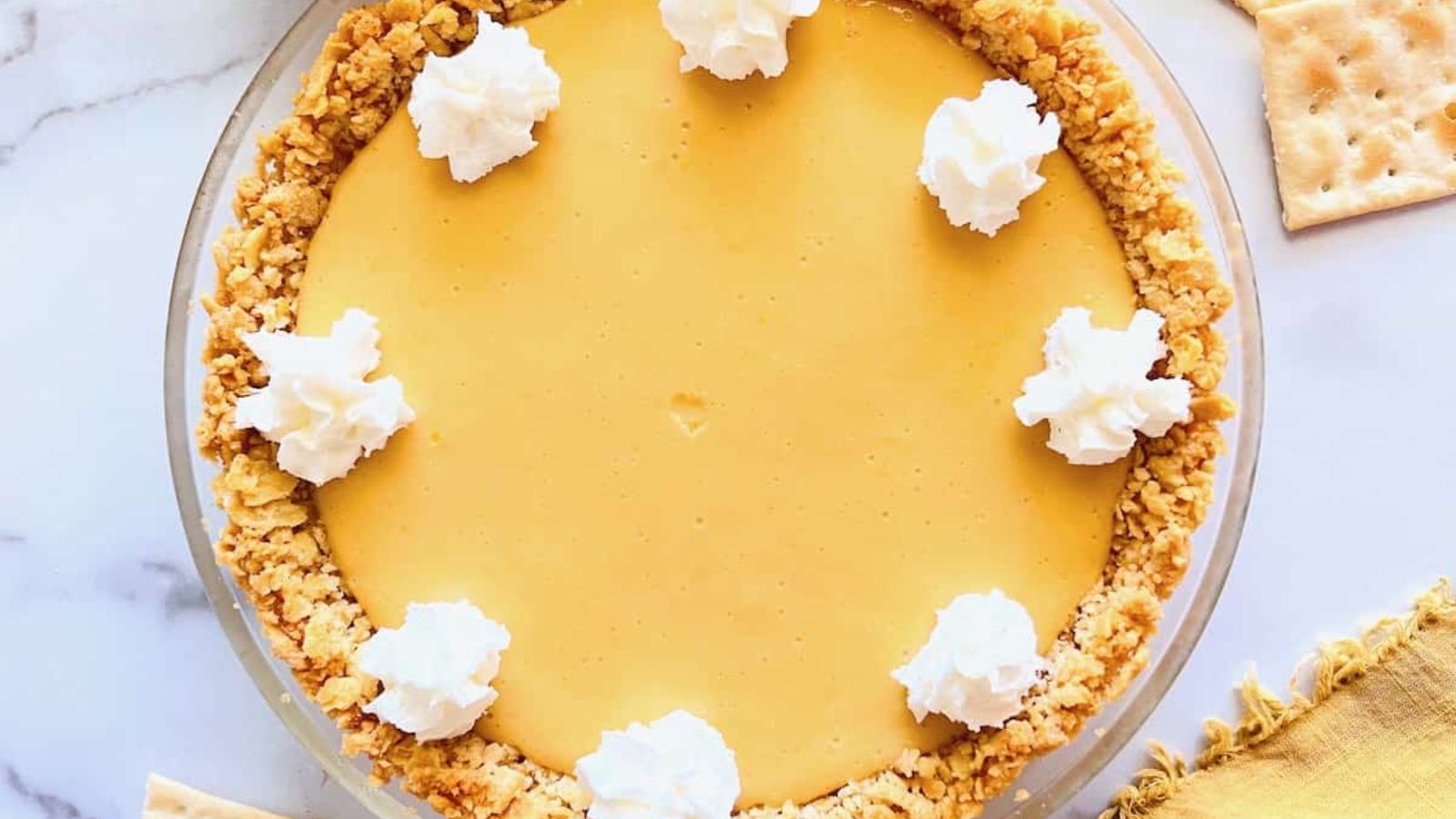 Lemon pie on a marble surface.