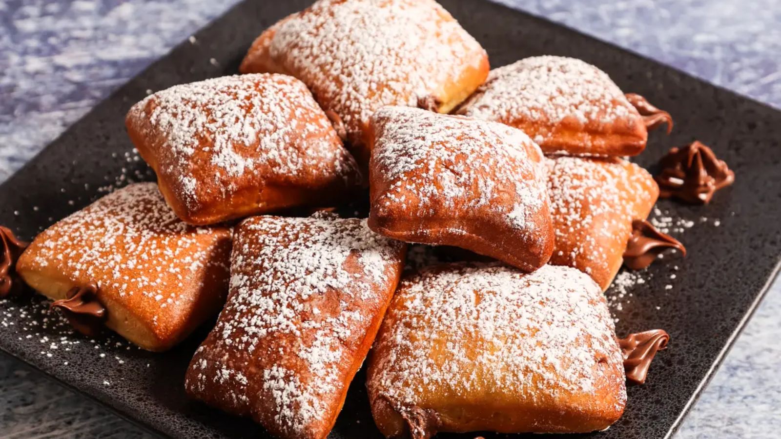 Stuffed beignets on a plate.
