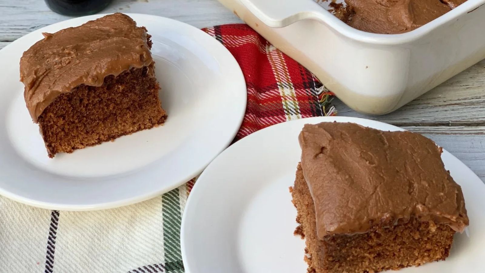 Slices of coca cola cakes on two plates.
